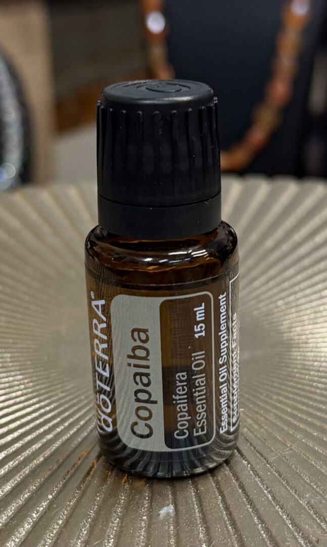 A 15 mL bottle of doTERRA Copaiba essential oil with a black cap.