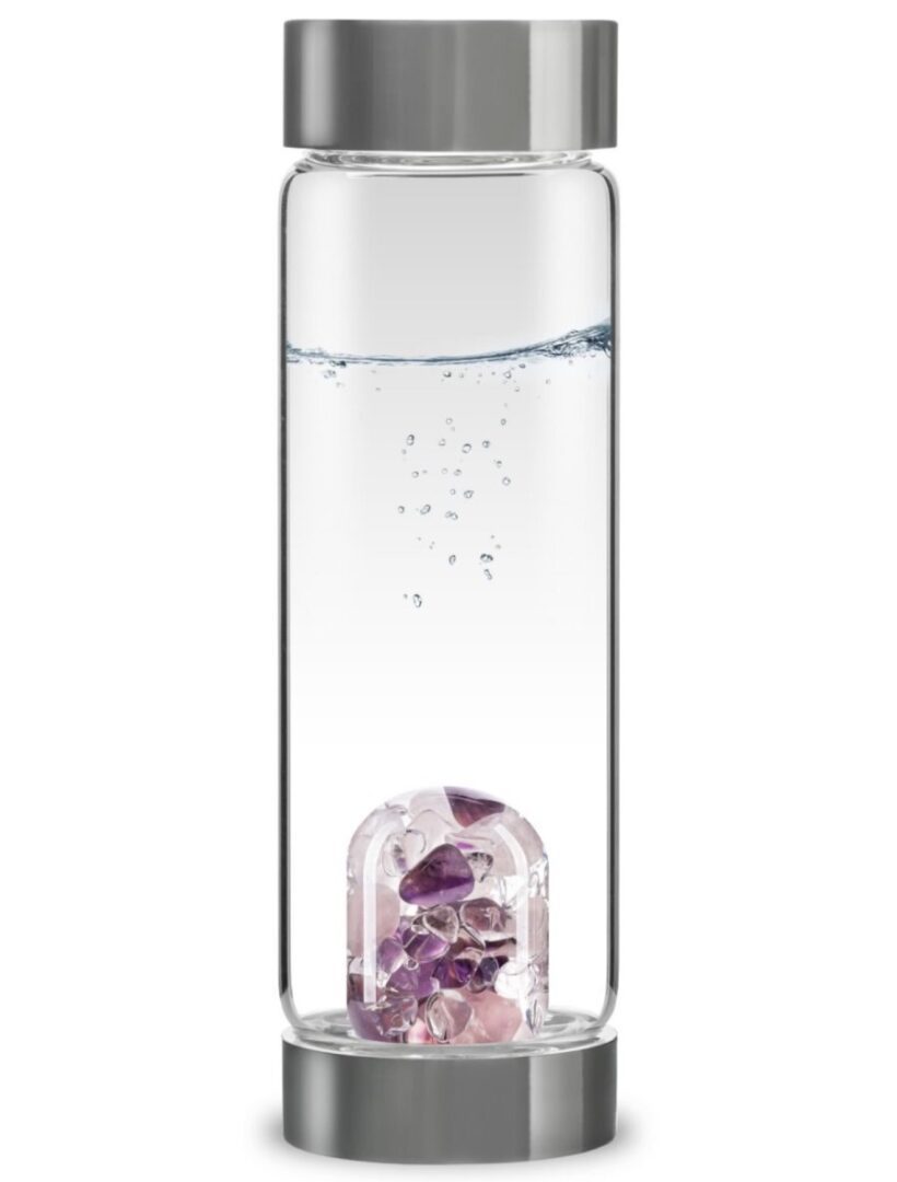 A clear water bottle with decorative purple crystals inside the base.