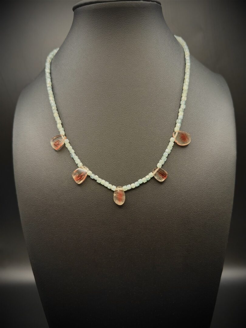 Delicate beaded necklace with translucent amber-like pendants.