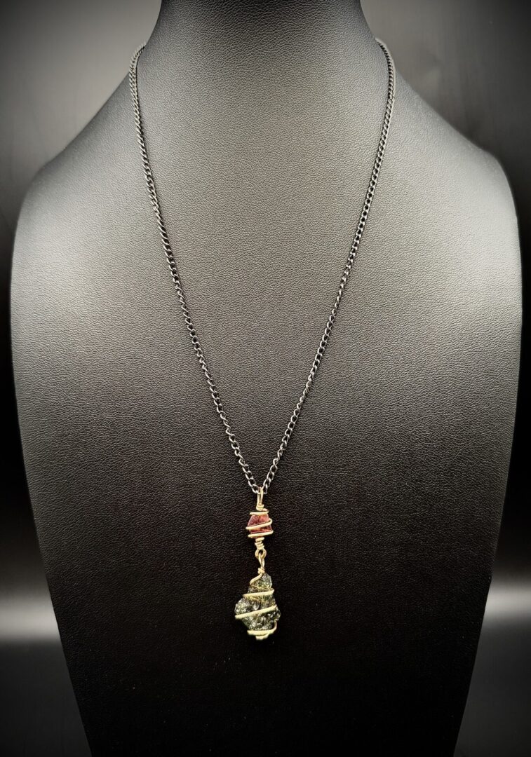 Elegant necklace with wire-wrapped stones on a black chain.