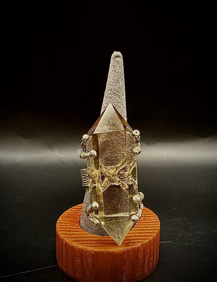 Elegant ring with a large clear crystal on a textured stand.