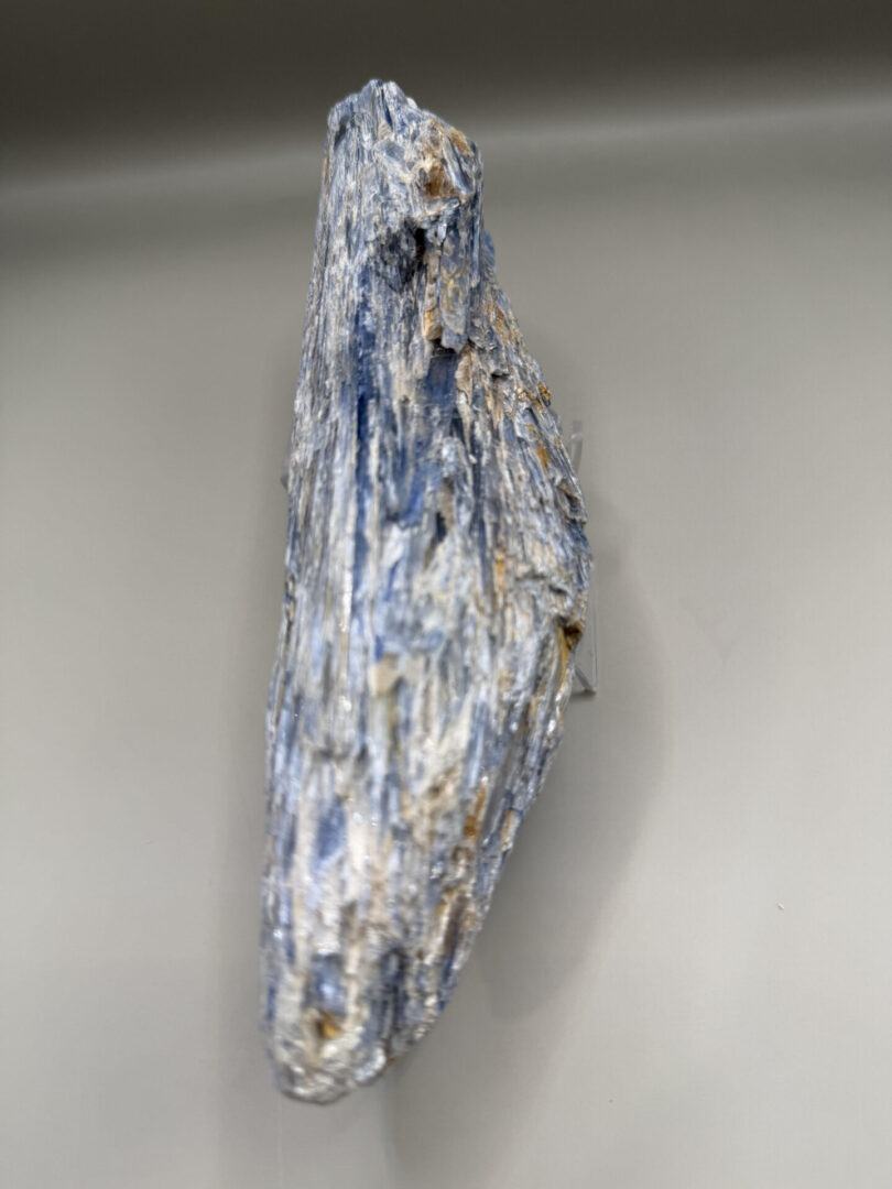 Close-up of a blue kyanite mineral with a rough texture.
