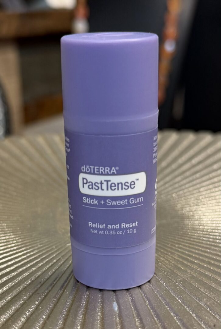 A purple doTERRA PastTense Stick for relief and reset.